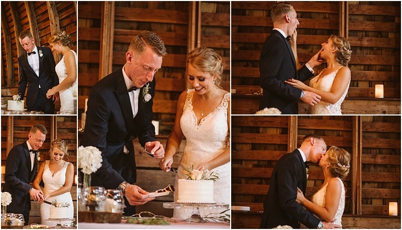 A bride and groom in formal attire smile cut their wedding cake feed each other cake laugh and kiss in a rustic snohomish wooden venue beautifully decorated with flowers Snohomish wedding photography