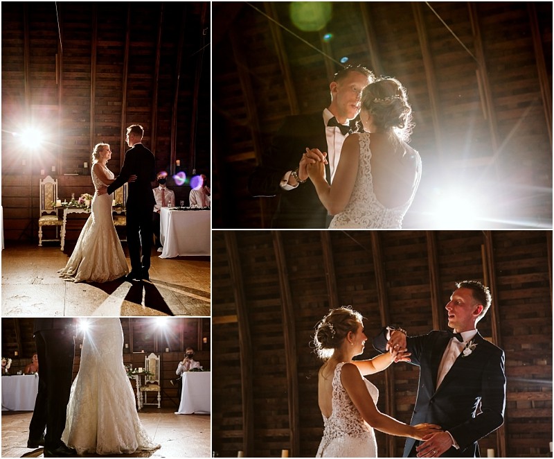 A bride and groom share their first dance in a rustic snohomish barn dressed in formal wedding attire with dramatic lighting and guests seated in the background Snohomish wedding photography