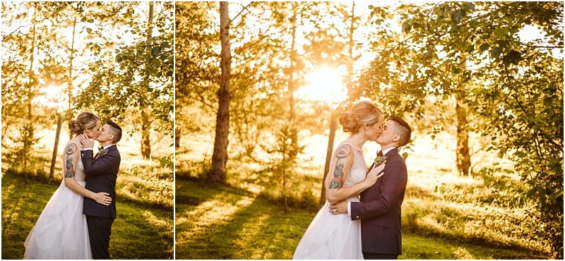 A couple dressed in wedding attire shares a kiss outdoors in snohomish surrounded by trees and golden sunlight filtering through the leaves creating a warm and romantic atmosphere Snohomish wedding photography
