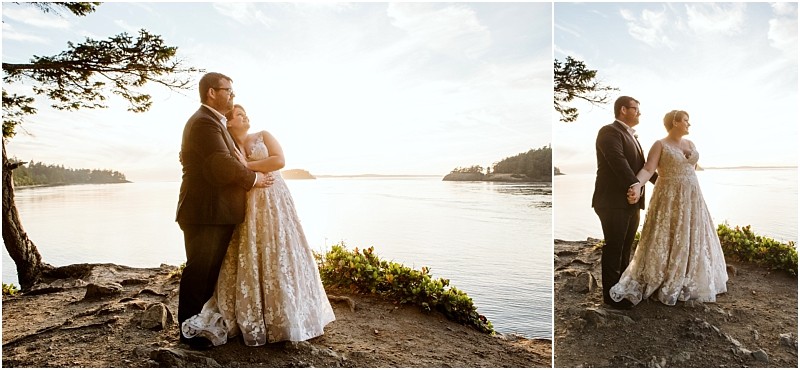 A bride and groom stand together on a rocky snohomish shoreline at sunset embracing and looking at each other lovingly with calm water and distant trees in the background Snohomish wedding photography