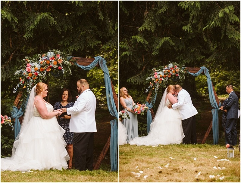 A bride and groom stand under a floral arch during their outdoor snohomish wedding ceremony In one image they hold hands as an officiant speaks in the other they share a kiss surrounded by greenery and witnesses Snohomish wedding photography