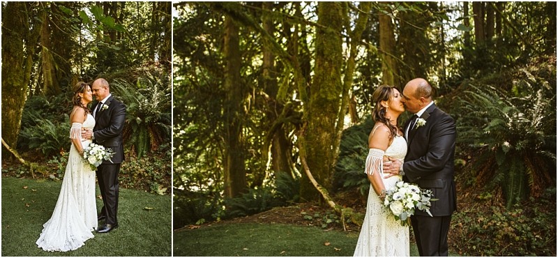 A bride and groom stand in a lush snohomish forest holding each other and kissing The bride wears an off the shoulder white dress and holds a bouquet the groom wears a dark suit as sunlight filters through the trees Snohomish wedding photography