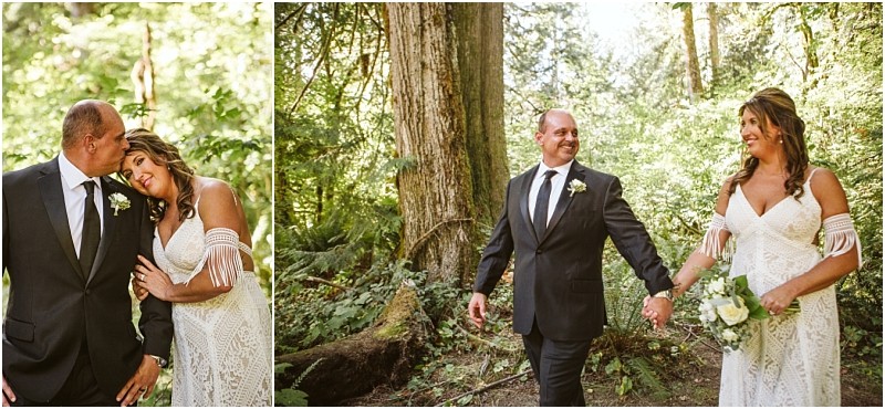 A bride and groom in formal attire walk hand in hand and share an affectionate moment in a lush sunlit snohomish forest The bride holds a bouquet of white flowers and leans her head lovingly on the grooms shoulder Snohomish wedding photography