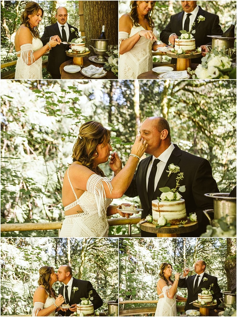 A bride and groom in wedding attire cut and feed each other cake outdoors in a sunlit snohomish forest they laugh kiss and toast with drinks surrounded by greenery and a rustic cake Snohomish wedding photography