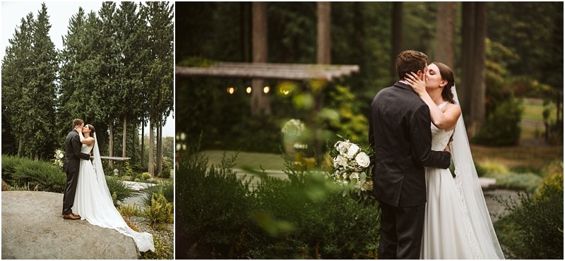 A bride and groom embrace outdoors in a lush snohomish garden The bride wears a white gown and holds a bouquet the groom is in a dark suit Tall trees and vibrant greenery surround them in this peaceful setting Snohomish wedding photography