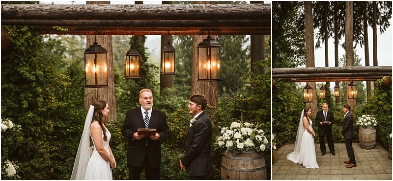 A bride and groom stand facing each other during an outdoor snohomish wedding ceremony with an officiant between them They are surrounded by greenery wooden beams hanging lanterns and elegant floral arrangements Snohomish wedding photography