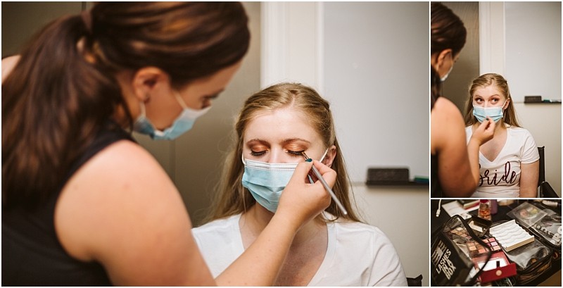 A makeup artist in snohomish applies eye makeup to a woman wearing a bride shirt and face mask Theres a close up view and a wider shot of makeup products on the table Both women are wearing masks Snohomish wedding photography