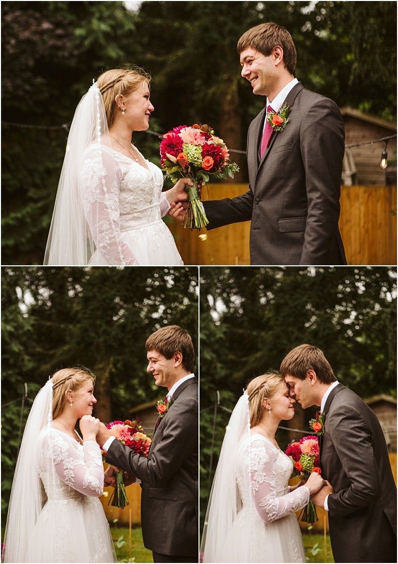 A bride and groom stand outside in snohomish smiling and holding a bouquet of bright flowers They share a joyful moment laughing and touching foreheads with trees and a wooden fence in the background Snohomish wedding photography