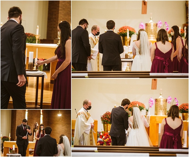 A bride and groom accompanied by bridesmaids and groomsmen in formal attire and masks participate in a beautiful snohomish church wedding ceremony with a priest lighting candles and standing at the altar adorned with flowers Snohomish wedding photography