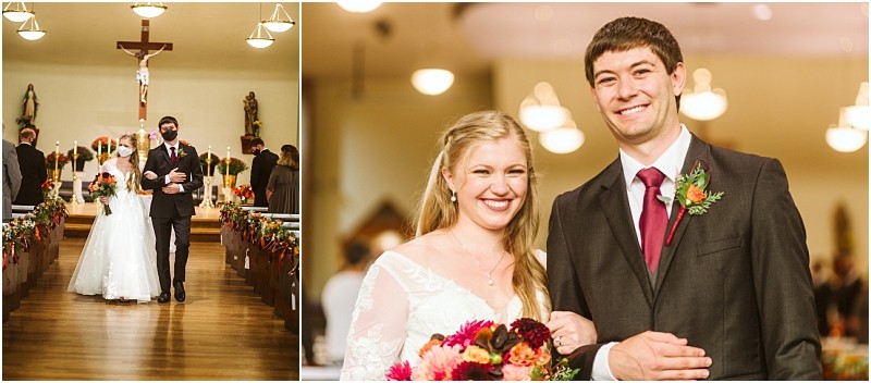 A bride and groom walk down the aisle together in a snohomish church and then smile arm in arm for a close up photo holding a colorful bouquet The church is beautifully decorated for their wedding Snohomish wedding photography
