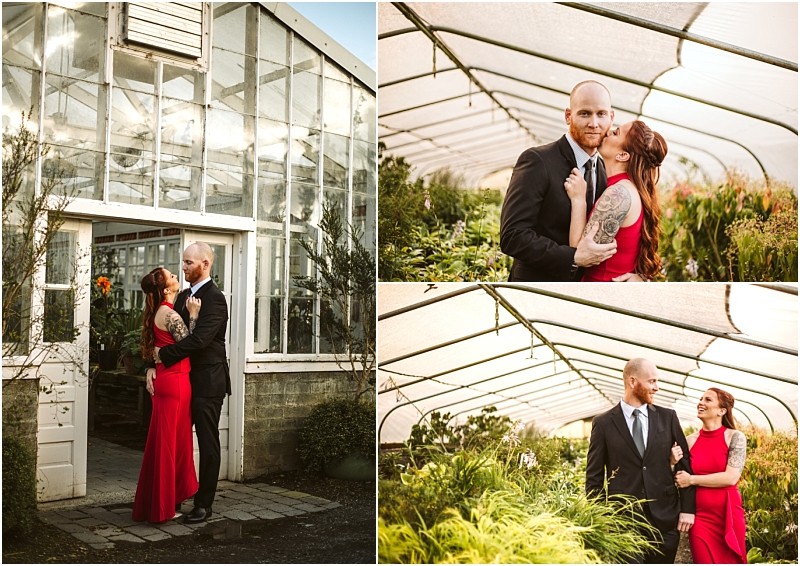 A couple dressed formally the woman in a red dress and the man in a black suit pose affectionately together outside and inside lush snohomish greenhouses filled with vibrant plants Snohomish wedding photography