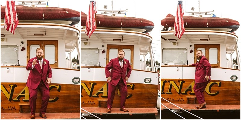 A bearded man in a maroon suit poses playfully in three different stances on a docked boat with wooden siding an american flag and a red dinghy on top in scenic snohomish Snohomish wedding photography