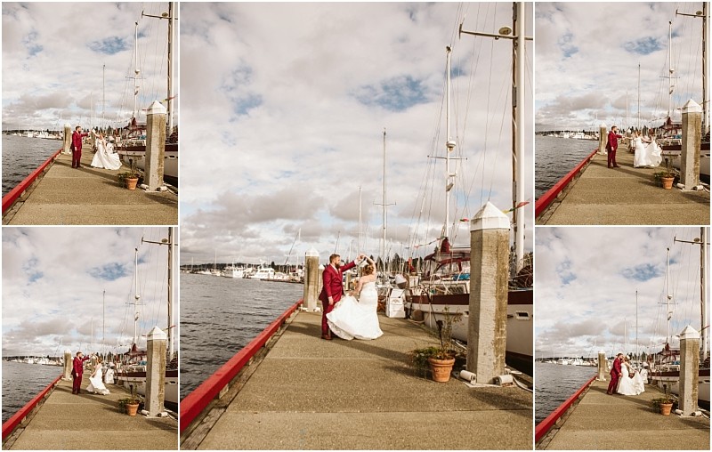 A bride and groom in wedding attire dance joyfully on a snohomish dock beside boats under a partly cloudy sky Water and marina scenery surround them creating a romantic nautical atmosphere Snohomish wedding photography
