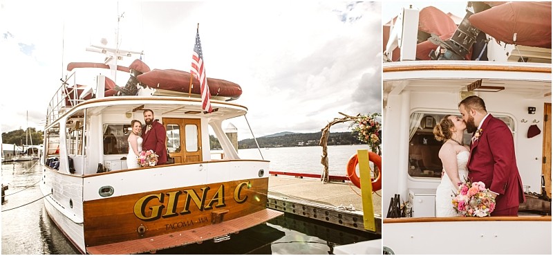A bride and groom stand on the deck of a boat named gina c docked at a snohomish marina They embrace and share a kiss with the bride holding a bouquet of flowers and the groom wearing a burgundy suit Snohomish wedding photography