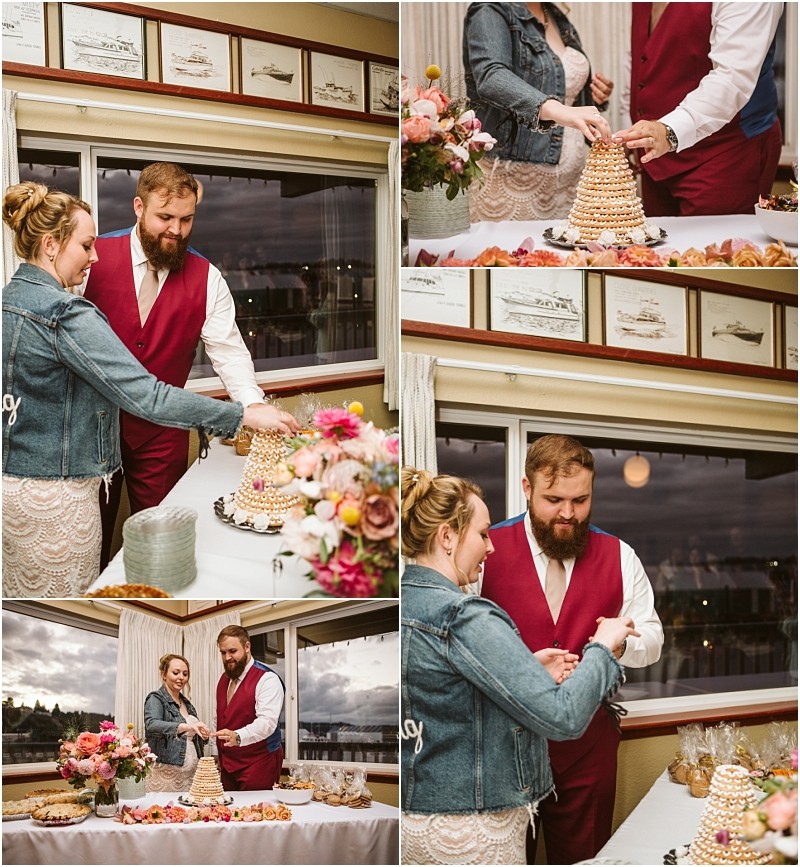 A couple cuts and shares a croquembouche wedding cake together in a cozy snohomish room decorated with flowers and framed pictures smiling and celebrating their special moment Snohomish wedding photography
