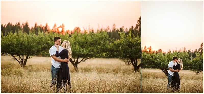 A couple stands in a grassy snohomish field at sunset embracing and sharing a kiss with trees and a warm orange sky in the background Snohomish wedding photography