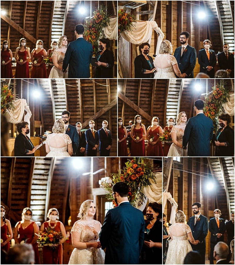A wedding ceremony in a rustic snohomish venue shows a couple exchanging vows before an officiant Bridesmaids in red and groomsmen in dark suits stand nearby with floral arrangements and wooden beams in the background Snohomish wedding photography