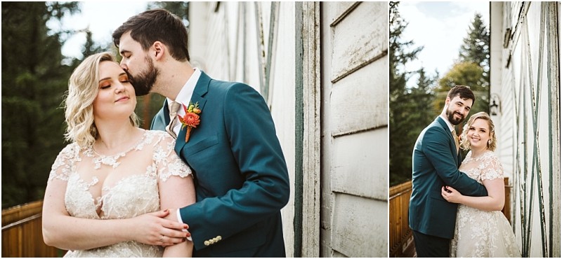 A couple in wedding attire stands closely together outside by a rustic white wooden wall in snohomish the groom kisses the brides forehead in one image and they both smile at the camera in the other Snohomish wedding photography