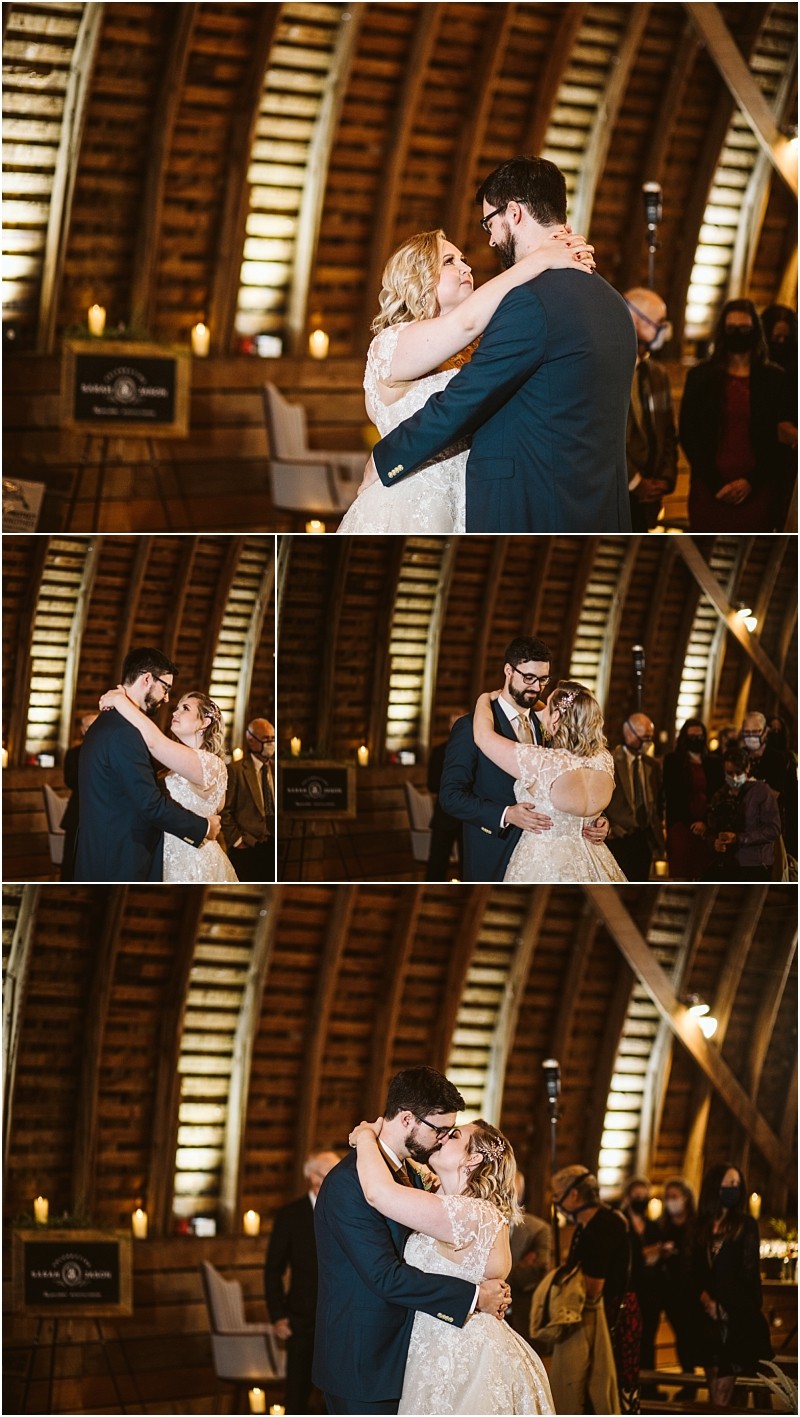 A bride and groom share their first dance in a warmly lit rustic snohomish barn venue surrounded by guests They embrace and smile at each other lost in the moment Snohomish wedding photography