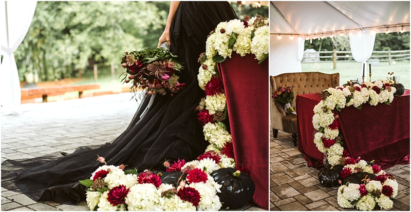 A person in a black dress stands next to a table draped in red velvet adorned with white and deep red flowers The rustic outdoor décor and string lights create a magical ambiance under a tent at this charming snohomish event Snohomish wedding photography
