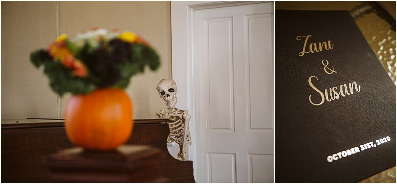 A halloween themed snohomish wedding scene with a skeleton peeking from behind a white door and a pumpkin vase of flowers on a piano next to a black wedding invitation for zane & susan dated october 31st 2020 Snohomish wedding photography