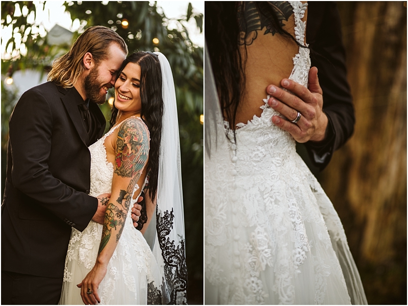 A groom in a black suit embraces a smiling tattooed bride in a white lace dress and veil at their snohomish wedding A close up shows his hand on her lower back highlighting his wedding ring and the dresss intricate lace details Snohomish wedding photography