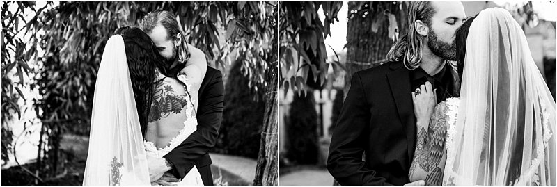 Two black and white photos of a bride and groom kissing outdoors in snohomish The bride with a visible back tattoo and veil embraces her long haired bearded groom under tree branches as they share a loving moment Snohomish wedding photography