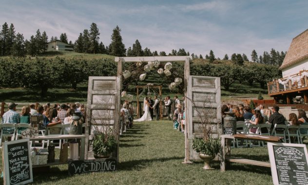 Hampton hideaway ceremony area with orchard and doors near the white barn