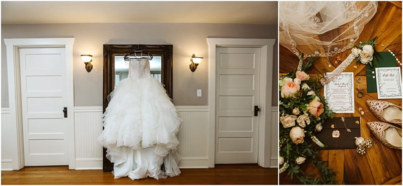A white wedding dress hangs on a mirror between two white doors; next to it, wedding accessories, invitations, flowers, and shoes are artfully arranged on a wooden surface in a charming Snohomish setting. Snohomish Wedding Photography
