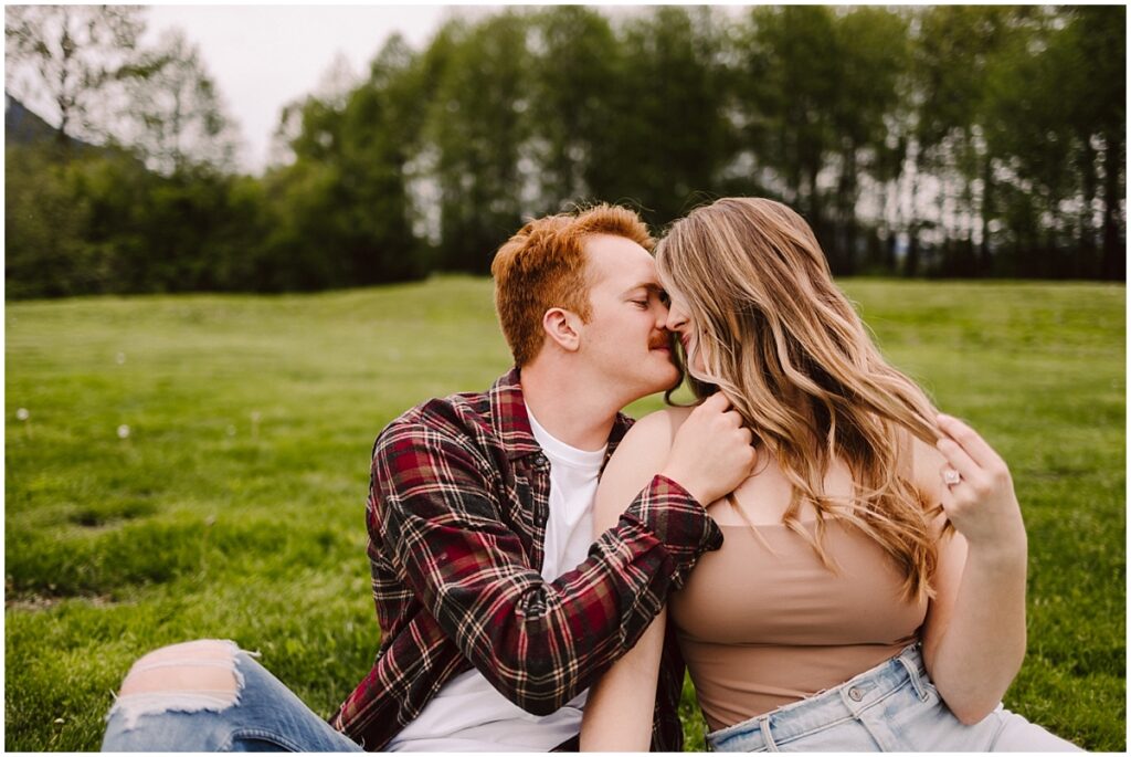 Meadowbrook farm engagement session bride and groom sitting on the grass snuggled up Meadowbrook farm engagement session bride and groom sitting on the grass snuggled up