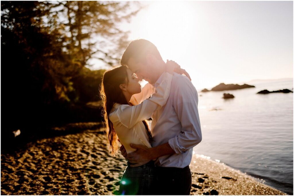 Rosario beach engagement session at sunset with bride and groom nose to nose and a warm sunflare behind them near oak harbor wa Rosario beach engagement session at sunset with bride and groom nose to nose and a warm sunflare behind them near oak harbor wa