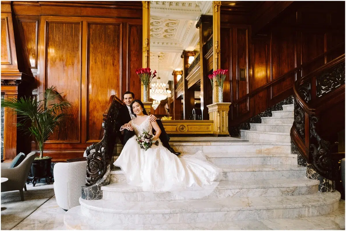 portland wedding at the benson hotel wedding couple bride and groom on the grand staircase