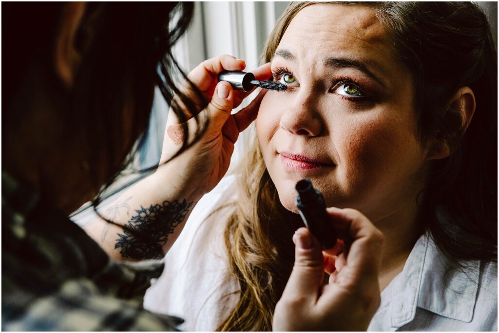 Snohomish wedding photographer gsquared weddings a woman with long brown hair is having mascara applied to her eyelashes by another person She is wearing a white shirt and sitting by a window looking slightly upward with a gentle expression Serving seattle snohomish and washington state Snohomish wedding photographer gsquared weddings a woman with long brown hair is having mascara applied to her eyelashes by another person She is wearing a white shirt and sitting by a window looking slightly upward with a gentle expression Serving seattle snohomish and washington state