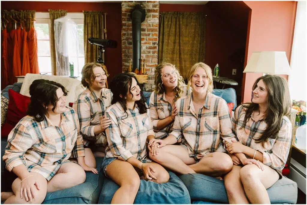 Snohomish Wedding Photographer GSquared Weddings Six people are sitting on a couch wearing matching plaid shirts and shorts casually chatting and laughing together The room has a cozy rustic vibe with a brick column and warmtoned walls Serving Seattle Snohomish and Washington State Snohomish Wedding Photographer GSquared Weddings Six people are sitting on a couch, wearing matching plaid shirts and shorts, casually chatting and laughing together. The room has a cozy, rustic vibe with a brick column and warm-toned walls. Serving Seattle, Snohomish and Washington State