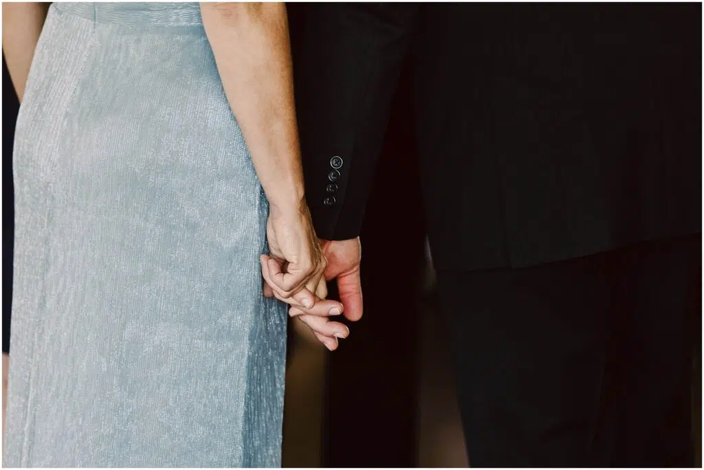 Snohomish Wedding Photographer GSquared Weddings A woman in a light blue textured dress and a man in a black suit are holding hands with the focus on their entwined fingers The image captures an intimate and supportive moment between the two Serving Seattle Snohomish and Washington State Snohomish Wedding Photographer GSquared Weddings A woman in a light blue textured dress and a man in a black suit are holding hands, with the focus on their entwined fingers. The image captures an intimate and supportive moment between the two. Serving Seattle, Snohomish and Washington State