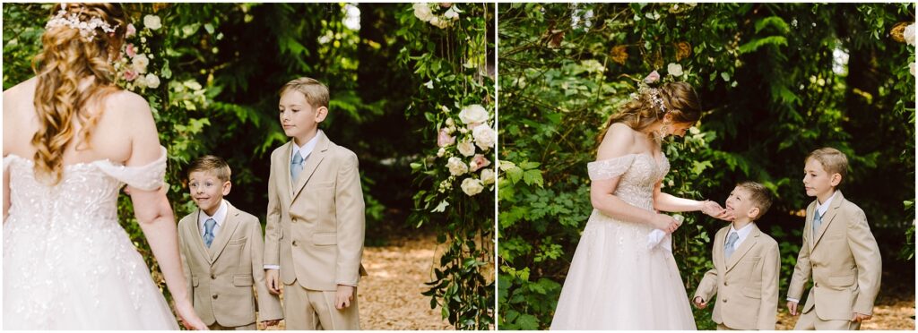 Snohomish wedding photographer gsquared weddings a bride in an off-shoulder gown stands with two young boys in beige suits in a lush green outdoor setting They are under an arch adorned with flowers as the bride interacts with the boys who look up at her Serving seattle snohomish and washington state Snohomish wedding photographer gsquared weddings a bride in an off shoulder gown stands with two young boys in beige suits in a lush green outdoor setting They are under an arch adorned with flowers as the bride interacts with the boys who look up at her Serving seattle snohomish and washington state