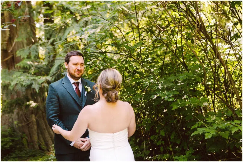 Snohomish Wedding Photographer GSquared Weddings A couple stands facing each other outdoors surrounded by lush greenery The groom in a dark suit looks at the bride who is wearing a white dress with her hair up Sunlight filters through the trees creating a serene atmosphere Serving Seattle Snohomish and Washington State Snohomish Wedding Photographer GSquared Weddings A couple stands facing each other outdoors, surrounded by lush greenery. The groom, in a dark suit, looks at the bride, who is wearing a white dress with her hair up. Sunlight filters through the trees, creating a serene atmosphere. Serving Seattle, Snohomish and Washington State