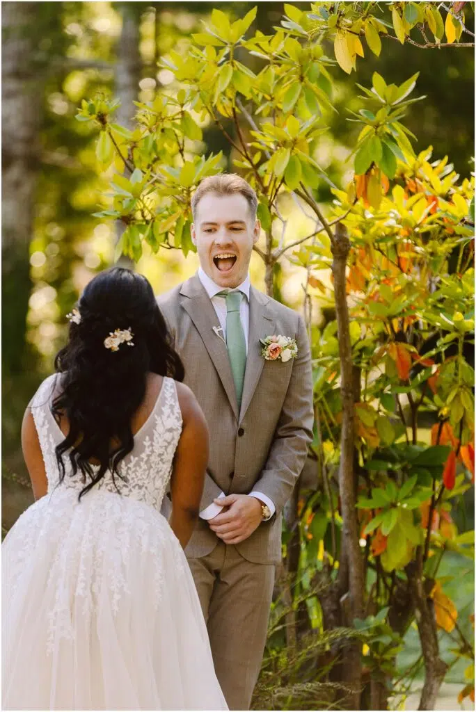 Snohomish Wedding Photographer GSquared Weddings A man in a light brown suit with a green tie looks surprised and happy as he faces a woman in a white lace dress They are outdoors surrounded by trees and foliage The woman has long dark hair with a white floral hairpiece Serving Seattle Snohomish and Washington State Snohomish Wedding Photographer GSquared Weddings A man in a light brown suit with a green tie looks surprised and happy as he faces a woman in a white lace dress. They are outdoors, surrounded by trees and foliage. The woman has long dark hair with a white floral hairpiece. Serving Seattle, Snohomish and Washington State