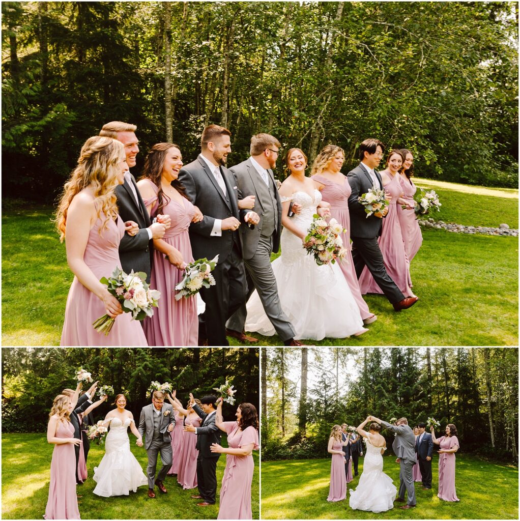 Snohomish Wedding Photographer GSquared Weddings A bride and groom walk arm-in-arm with their wedding party on a grassy outdoor area. Bridesmaids in pink dresses and groomsmen in gray suits surround them. They smile and celebrate under a sunny, tree-filled backdrop. Serving Seattle, Snohomish and Washington State