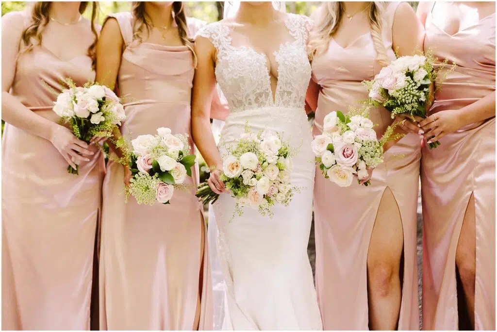 Snohomish Wedding Photographer GSquared Weddings A bride in a white gown stands with four bridesmaids in matching pink dresses each holding a bouquet of white and pink flowers The setting appears to be outdoors with greenery in the background Serving Seattle Snohomish and Washington State Snohomish Wedding Photographer GSquared Weddings A bride in a white gown stands with four bridesmaids in matching pink dresses, each holding a bouquet of white and pink flowers. The setting appears to be outdoors, with greenery in the background. Serving Seattle, Snohomish and Washington State