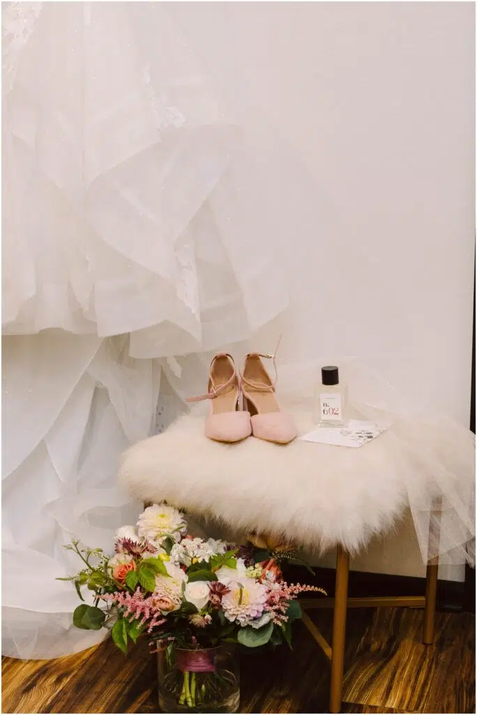 Snohomish Wedding Photographer GSquared Weddings A wedding dress hangs beside a small stool with pink heels a bottle of perfume and a note on it Below theres a bouquet of flowers in a glass vase on a wooden floor Serving Seattle Snohomish and Washington State Snohomish Wedding Photographer GSquared Weddings A wedding dress hangs beside a small stool with pink heels, a bottle of perfume, and a note on it. Below, theres a bouquet of flowers in a glass vase on a wooden floor. Serving Seattle, Snohomish and Washington State