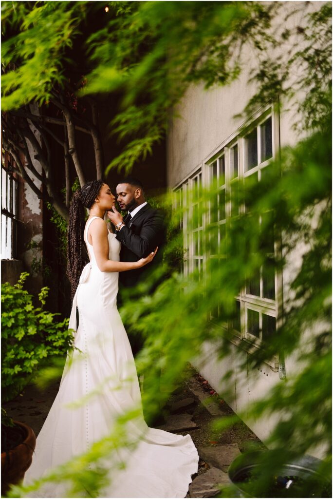Snohomish wedding photographer gsquared weddings a bride in a white dress and a groom in a black suit share a close moment against a wall with windows They are surrounded by lush greenery creating an intimate and romantic atmosphere Serving seattle snohomish and washington state Snohomish wedding photographer gsquared weddings a bride in a white dress and a groom in a black suit share a close moment against a wall with windows They are surrounded by lush greenery creating an intimate and romantic atmosphere Serving seattle snohomish and washington state