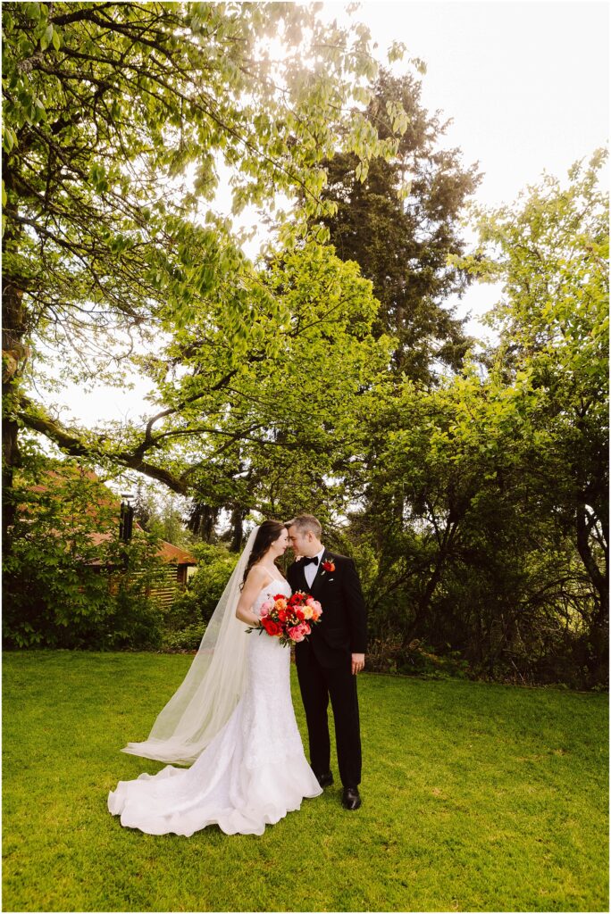 Snohomish wedding photographer gsquared weddings a bride and groom kiss in a garden setting The bride wears a long white dress with a veil and holds a colorful bouquet The groom is in a black suit with a boutonniere They are surrounded by lush green trees with sunlight filtering through Serving seattle snohomish and washington state Snohomish wedding photographer gsquared weddings a bride and groom kiss in a garden setting The bride wears a long white dress with a veil and holds a colorful bouquet The groom is in a black suit with a boutonniere They are surrounded by lush green trees with sunlight filtering through Serving seattle snohomish and washington state