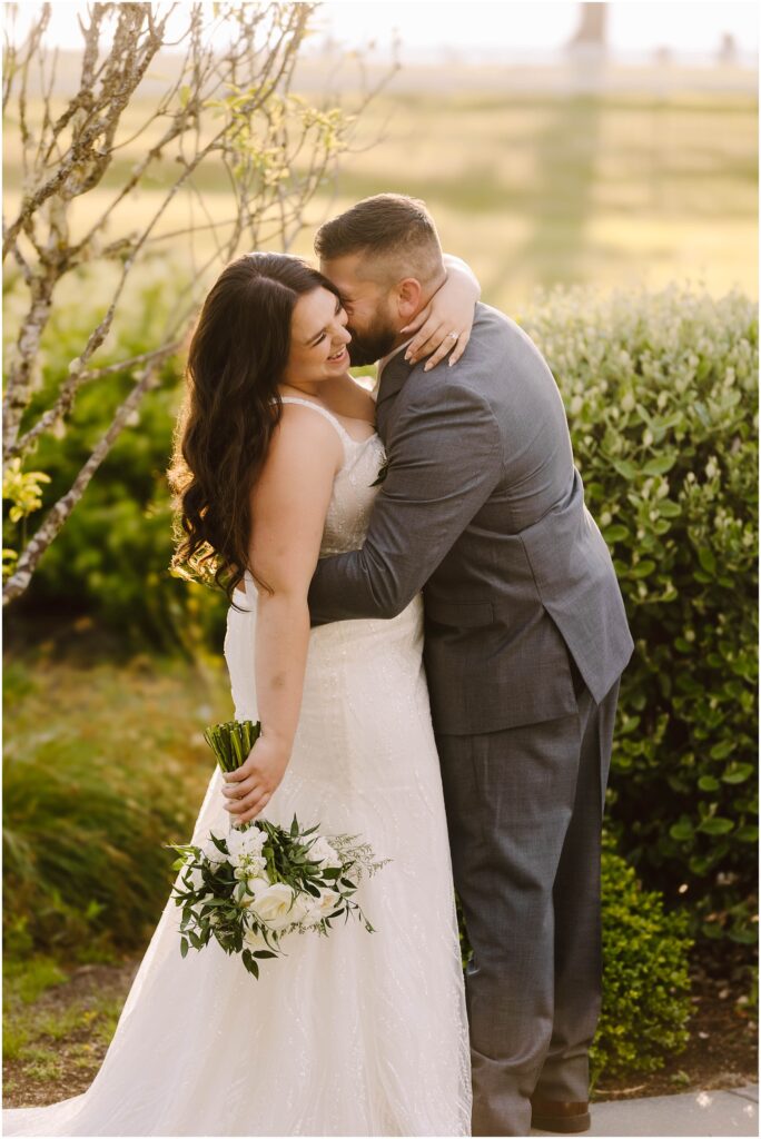 Snohomish wedding photographer gsquared weddings a couple embraces outdoors in a garden setting The bride is wearing a white dress and holding a bouquet of white flowers The groom is in a gray suit They are smiling and appear joyful with the sun softly illuminating the scene Serving seattle snohomish and washington state Snohomish wedding photographer gsquared weddings a couple embraces outdoors in a garden setting The bride is wearing a white dress and holding a bouquet of white flowers The groom is in a gray suit They are smiling and appear joyful with the sun softly illuminating the scene Serving seattle snohomish and washington state