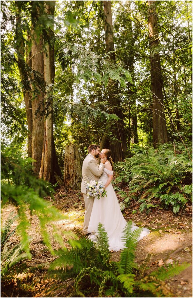 Snohomish wedding photographer gsquared weddings a bride and groom share a kiss in a lush forest setting The bride holds a bouquet and sunlight filters through the tall trees and leafy greenery creating a serene and romantic atmosphere Serving seattle snohomish and washington state Snohomish wedding photographer gsquared weddings a bride and groom share a kiss in a lush forest setting The bride holds a bouquet and sunlight filters through the tall trees and leafy greenery creating a serene and romantic atmosphere Serving seattle snohomish and washington state