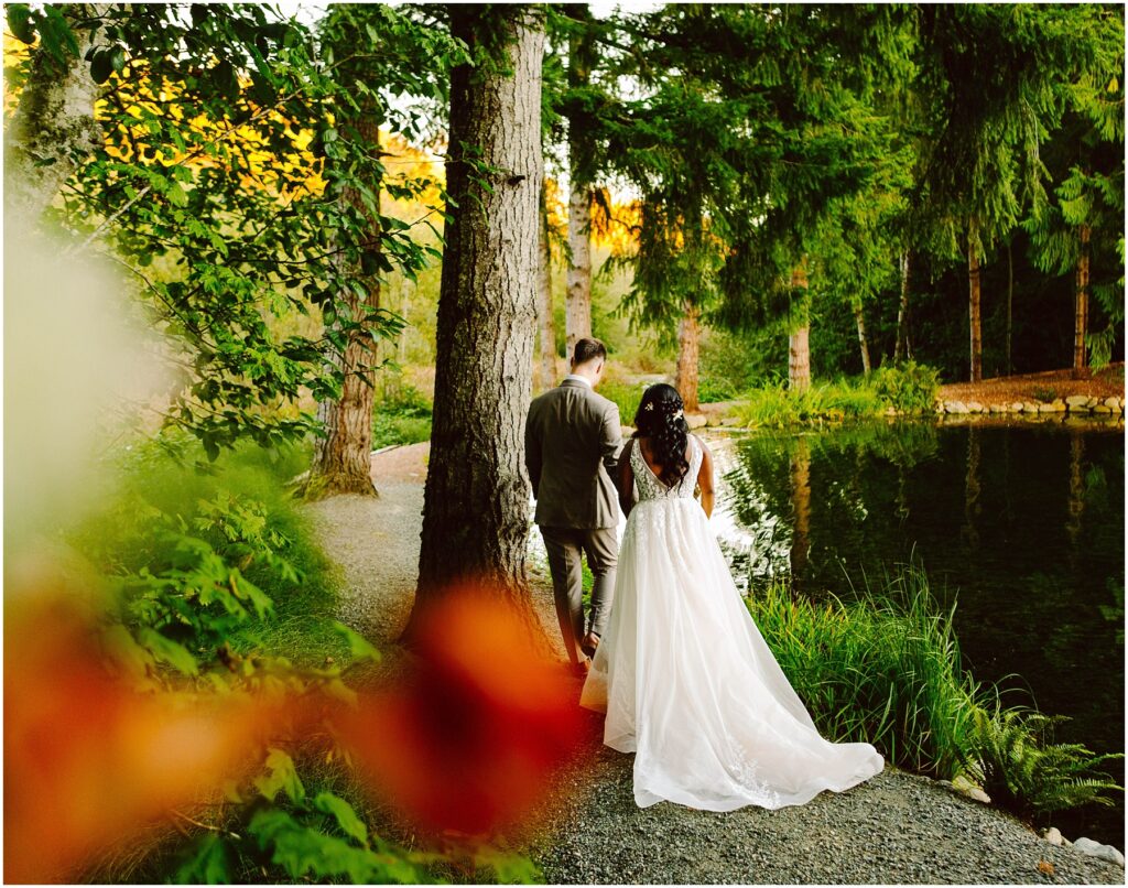 Snohomish wedding photographer gsquared weddings bride and groom walking along a wooded path beside a serene lake surrounded by lush greenery and tall trees The bride is in a white dress and the groom is in a suit The scene is vibrant with hints of autumn colors Serving seattle snohomish and washington state Snohomish wedding photographer gsquared weddings bride and groom walking along a wooded path beside a serene lake surrounded by lush greenery and tall trees The bride is in a white dress and the groom is in a suit The scene is vibrant with hints of autumn colors Serving seattle snohomish and washington state