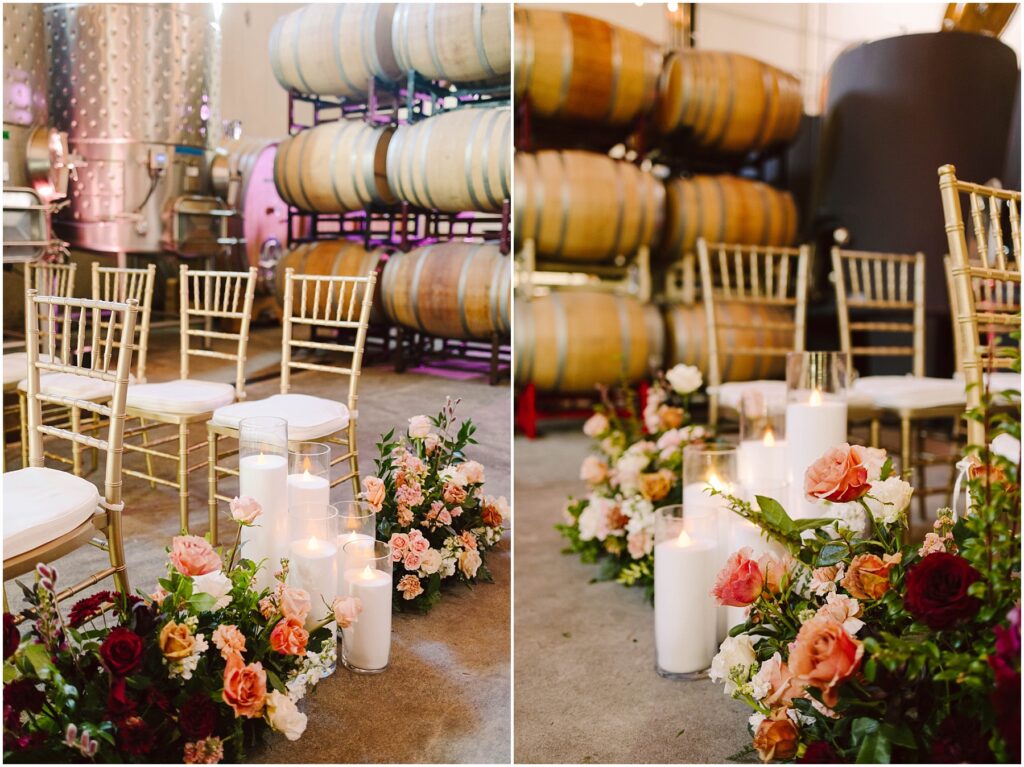 Snohomish Wedding Photographer GSquared Weddings Rows of gold chairs are arranged indoors beside large wine barrels. Floral arrangements with red, pink, and orange flowers, accompanied by lit candles, decorate the aisle. The setting has a warm and inviting atmosphere. Serving Seattle, Snohomish and Washington State