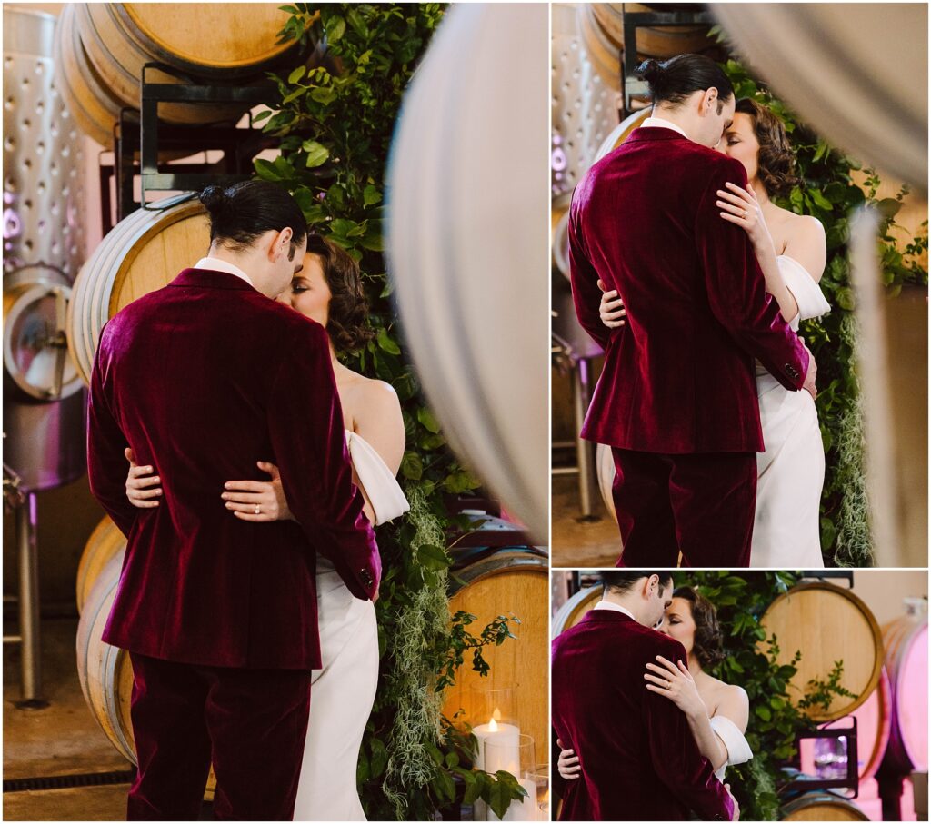 Snohomish Wedding Photographer GSquared Weddings A couple shares an intimate moment in front of wine barrels. The man wears a burgundy suit, while the woman is in a white dress. They embrace closely, surrounded by greenery and soft lighting. Serving Seattle, Snohomish and Washington State