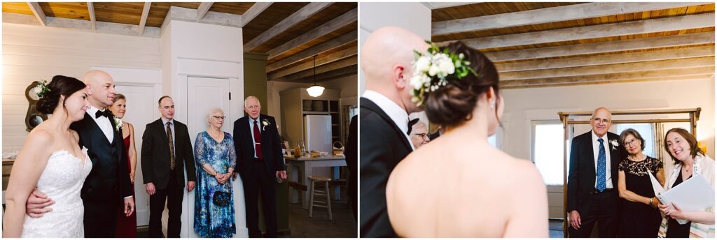 Snohomish Wedding Photographer GSquared Weddings Wedding ceremony with a couple and guests in a cozy room. The bride wears a white dress and flower crown, while the groom is in a suit. Other guests, wearing formal attire, stand nearby. The room has wooden ceilings and bright natural light. Serving Seattle, Snohomish and Washington State
