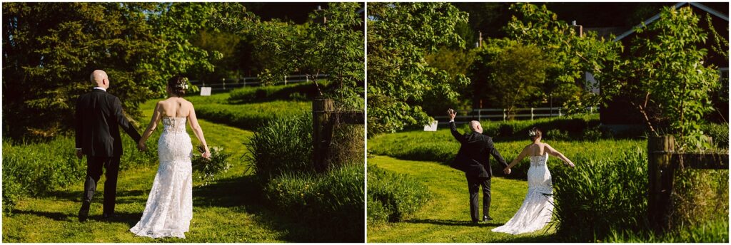 Snohomish Wedding Photographer GSquared Weddings A couple walks hand in hand on a sunlit grassy path, surrounded by lush greenery. The bride wears a strapless white gown, while the groom wears a black suit. They raise their joined hands in celebration, moving toward a scenic, tree-lined backdrop. Serving Seattle, Snohomish and Washington State